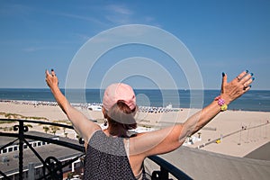 Senior woman baby boomer wearing pink baseball cap and ponytail