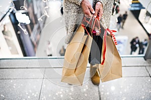 Senior woman with bags doing Christmas shopping.