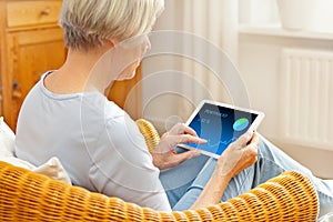 Senior woman banking tablet computer photo