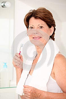 Senior woman in bathroom with toothbrush