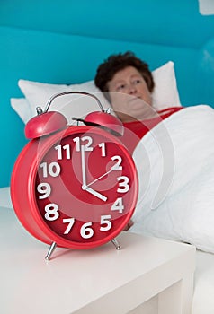 Senior woman in bed ill and suffered of sleeplessness or insomnia.