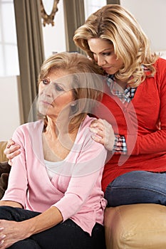 Senior Woman Being Consoled By Adult Daughter