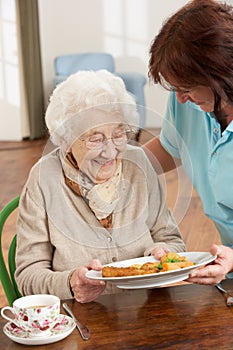 Senior Woman Being Served Meal