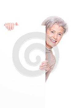 Senior woman with blank sign