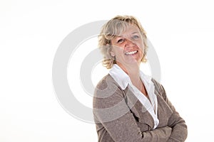 Senior woman blonde with arms crossed blonde hairs laughing on white background smiling pretty mature in studio wall portrait