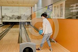 senior woman in a bowling club throws a ball