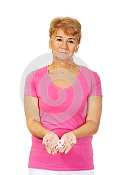 Senior woman with breast cancer awareness ribbon