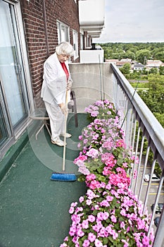 Senior woman brooming