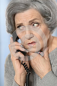 Senior woman calling her doctor
