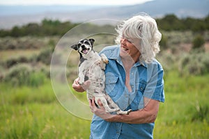 Senior Woman Carrying her Pet Dog