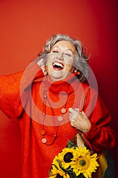 Senior woman carrying a sunflower bouquet