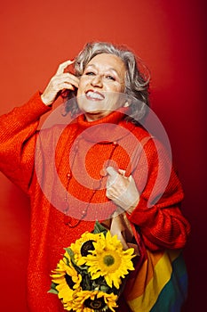 Senior woman carrying a sunflower bouquet
