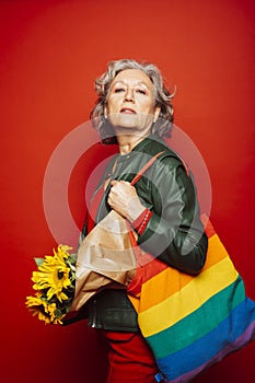 Senior woman carrying a sunflower bouquet