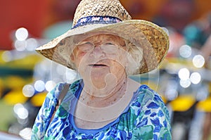 Senior woman celebrating Australia Day in traditional flags hat outdoors