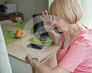 Senior woman checking health information using smart watch, modern healthcare and support