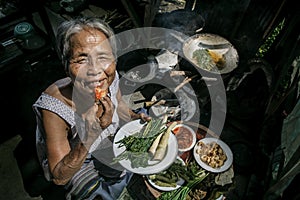 Senior woman chef cooks in the kitchen