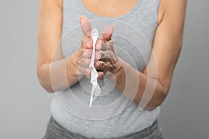 Senior woman cleaning hands with wet wipes - prevention of infectious diseases
