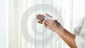 Senior woman cleaning her hands with white soft tissue paper. isolated on a white backgrounds