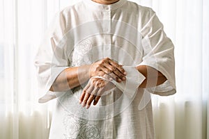 Senior woman cleaning her hands with white soft tissue paper. isolated on a white backgrounds