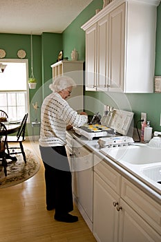 Senior woman cooking breakfast