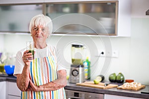Senior woman cooking in the kitchen - eating and cooking healthy