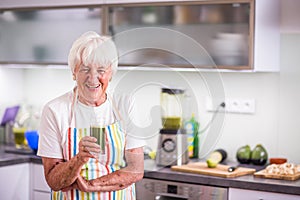 Senior woman cooking in the kitchen - eating and cooking healthy