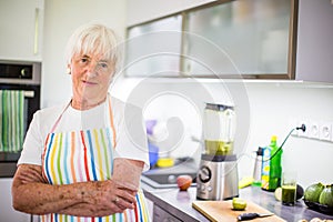 Senior woman cooking in the kitchen - eating and cooking healthy