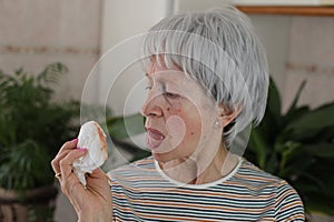 Senior woman coughing saliva with blood