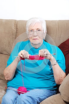 Senior woman counting knitting stitches