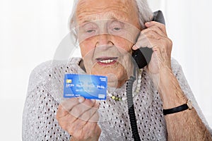 Senior Woman With Credit Card On Phone