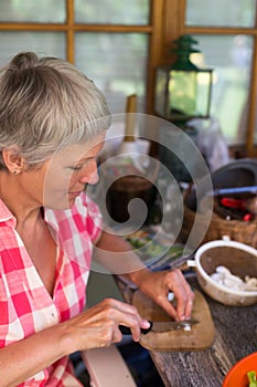 Senior woman cutting food