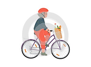 Senior woman cycles on bicycle with basket