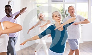 Senior woman dancing hip hop in studio practicing dance number.