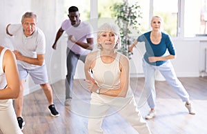 Senior woman dancing hip hop in studio practicing dance number.