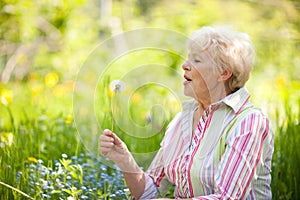 Senior woman with dandelion