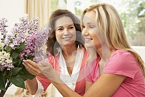 Senior Woman And Daughter Arranging Flowers