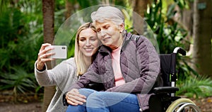 Senior woman, daughter and selfie at outdoor park with elderly in wheelchair for rehabilitation and air with hospice or