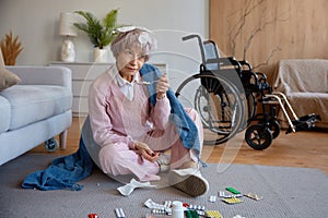 Senior woman with dementia mental disorder eating pills scattered on floor