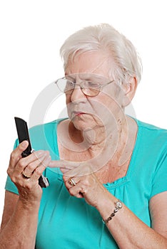 Senior woman dialing a number on cellphone