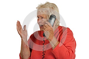 Senior woman is discussing while telephoning