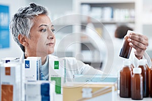 Senior woman, doctor and medicine for healthcare prescription checking stock on shelf in pharmacy. Elderly female