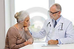 Senior woman and doctor with tablet pc