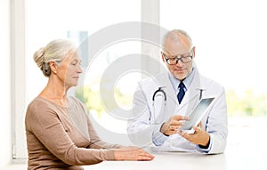 Senior woman and doctor with tablet pc