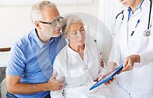 Senior woman and doctor with tablet pc at hospital