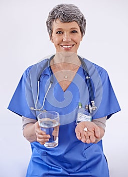 Senior woman, doctor and water with pills, healthcare with medication treatment and supplements on white background