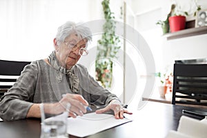 Senior woman doing Alzheimer`s disease or dementia clock drawing self assessment test