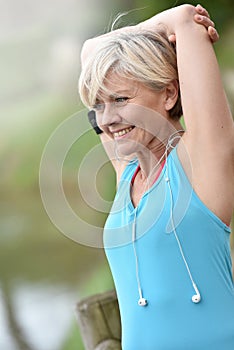Senior woman doing excercises outdoors