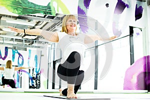 Senior woman doing exercise at gym