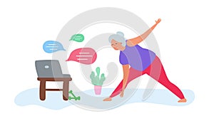 Senior woman doing exercise  at home watching laptop online training healthy lifestyle
