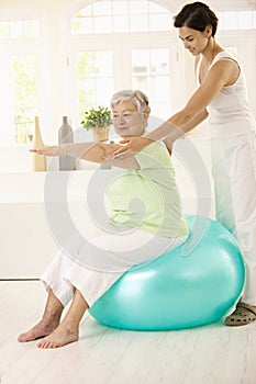 Senior woman doing fit ball exercise